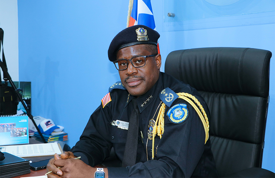 Liberia National Police Inspector General Gregory Coleman seated at his desk in uniform